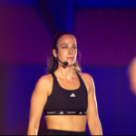 Sapir Ofer wearing a headset and wearing gym clothing
