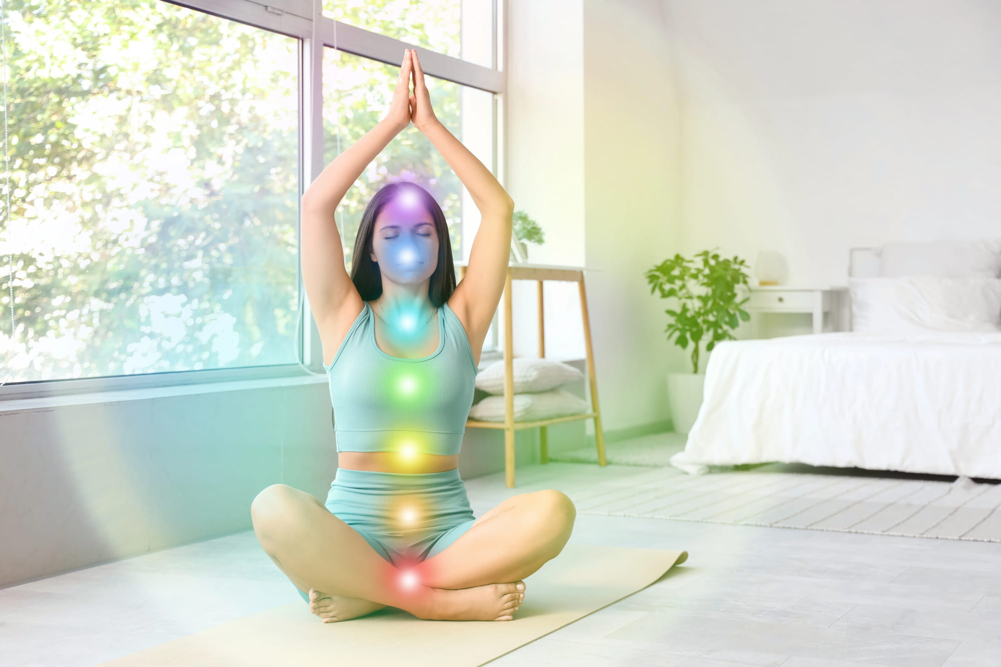 woman in lotus position with chakras visible