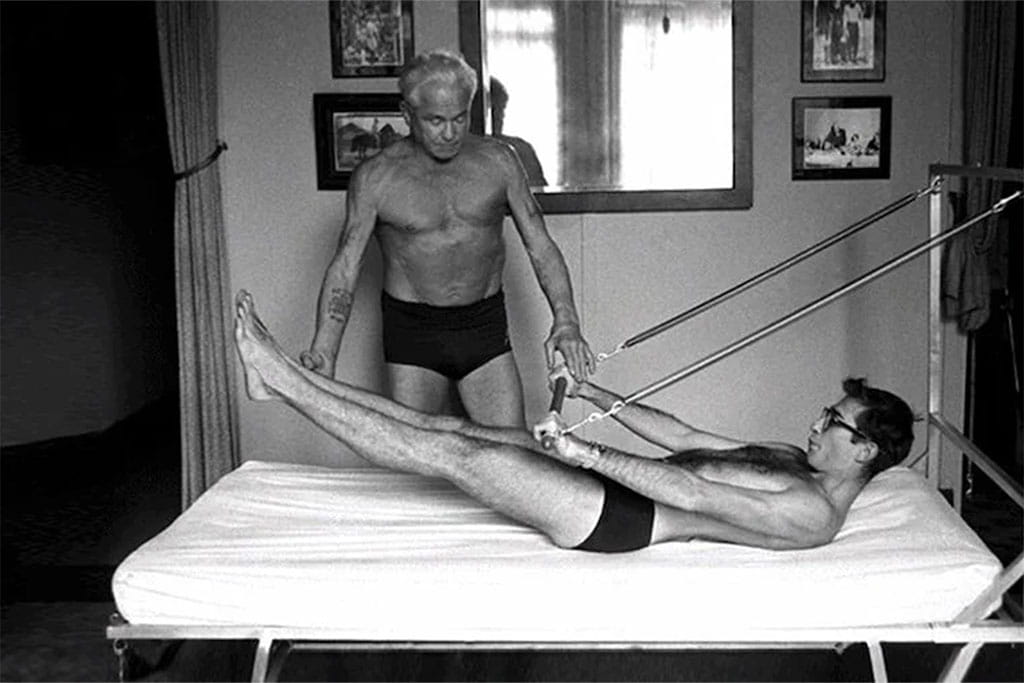 Joseph Pilates teaching with the Pilates tower